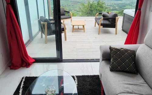 a living room with a couch and a glass table at Les Suites DNJ Martinique in Le François