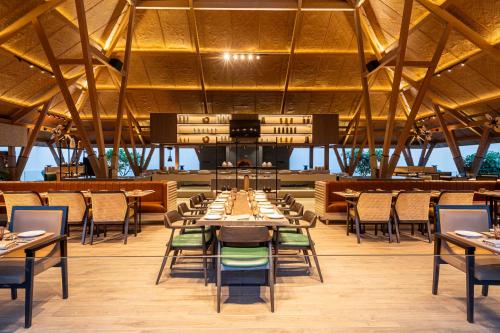 a large dining room with tables and chairs at Radisson Resort Hatgad Saputara in Saputara
