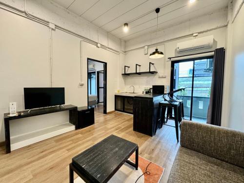 a living room with a desk and a piano at The51Hometel in Chiang Mai