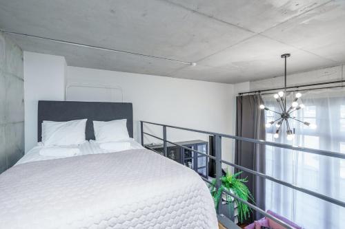 a bedroom with a white bed and a window at Dream Stay - Modern City Centre Lofts with Self Check-in in Tallinn