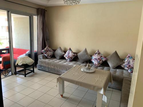 a living room with a couch and a table at Bahia Golf Beach, Bouznika in Bouznika