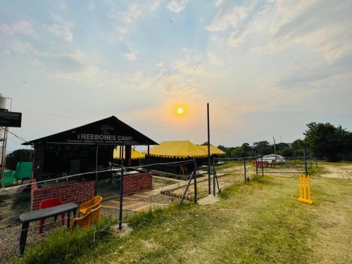 a black tent with the sun in the sky at Tree Bones Camp in Bīr