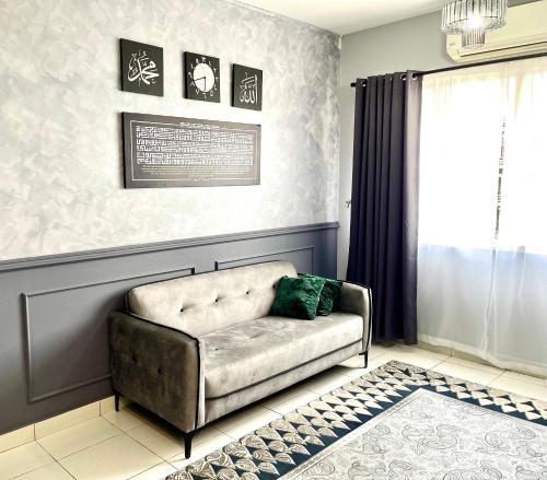 a living room with a couch and a window at DP Islamic Homestay in Setia Alam