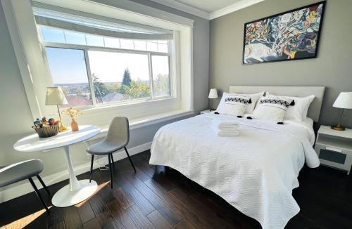 a bedroom with a white bed and a window at Jennifer's House in Vancouver