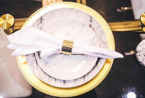 a gold and white plate with a bow on it at Island Haven Hideaway 5BR in Nassau