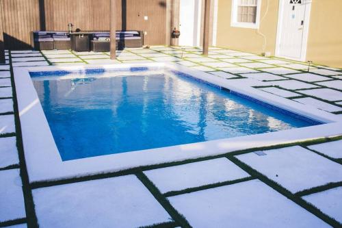 a swimming pool with blue water in a house at Island Haven Hideaway 5BR in Nassau