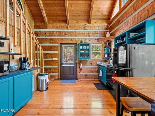 a kitchen with blue cabinets and a blue door at Bluff Mountain's Private Retreat in Sevierville