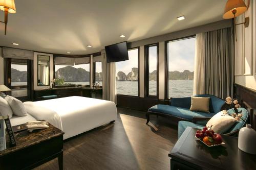 a hotel room with a large bed and a couch at Amanda Luxury Cruise in Ha Long