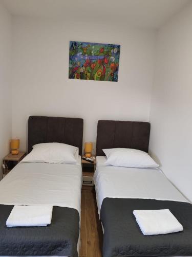 two beds sitting next to each other in a room at Adriatica in Zadar