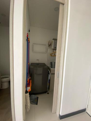 a hallway leading to a kitchen with a door open at Modern well-equipped 4 PPL condo/5 MIN beach walk in Santa Marta