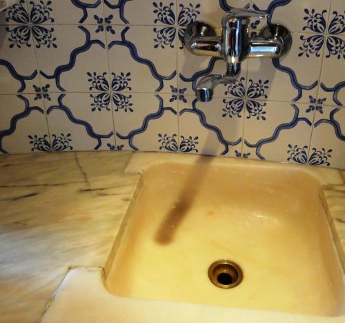 a sink in a bathroom with a faucet at Herdade do moinho in Santiago do Cacém
