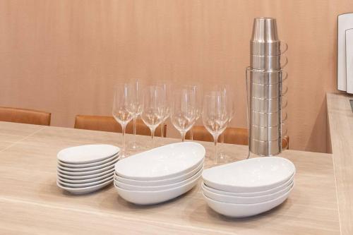 a table with white plates and wine glasses on it at THE SECOND Chousei Beach Village平屋ペット不可 in Jōnouchi