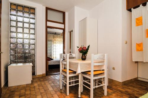 a kitchen and dining room with a table and chairs at Guesthouse Lanca in Tivat
