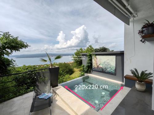 a villa with a swimming pool and a view of the ocean at Art Gallery House with a small relaxing pool in Crikvenica