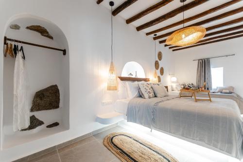 a bedroom with a bed in a room with white walls at Yria Traditional House in Vívlos