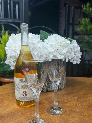 a bottle of wine and two glasses on a table at Golden Fleece Hotel in Ureki