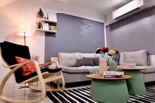 a living room with a couch and a table at Spacious 4BRTownhouse BTS Onnut 10 Sleeps with Parking in Amphoe Phra Khanong
