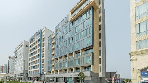 a large building with many windows on a city street at Daynice hotel in Boryeong