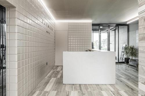 an office with white tile walls and a white reception counter at Daynice hotel in Boryeong