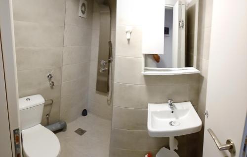 a small bathroom with a toilet and a sink at Stavros Lay In in Áno Stavrós