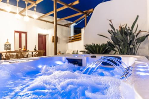 a jacuzzi tub filled with blue water at Yria Traditional House in Vívlos