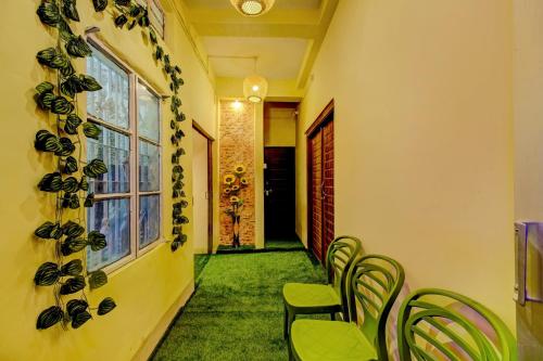 a row of chairs in a hallway with a window at SPOT ON Rainbow Lodge in Guwahati