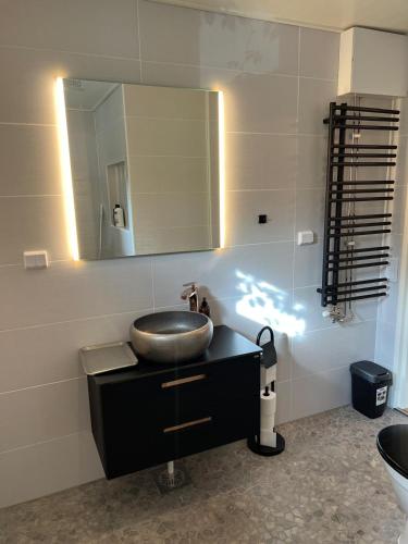 a bathroom with a sink and a mirror at Fabulous 2 Bedroom Apartment in Vaasa