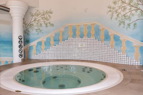 a jacuzzi tub in a room with a staircase at Residenz Ambassador in Leukerbad