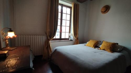 a bedroom with a bed and a window at Le Champcevrais in Champcevrais