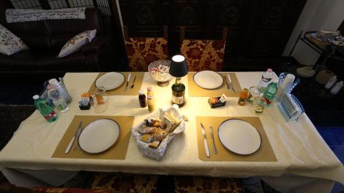 a table with plates and mirrors on top of it at B&B villamariascauri in Scauri