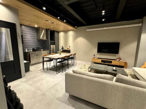 a living room with a couch and a table at TABISAI HOTEL Lunon Tenjin in Fukuoka