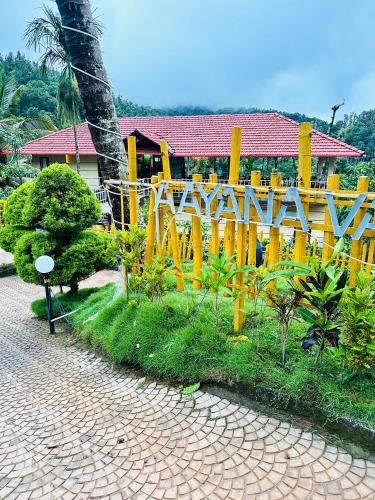 a yellow fence with a sign that reads sanctuary at Aayana Valley in Chikmagalur