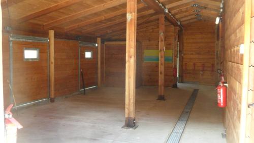 a large room with wood walls and a fire extinguisher at B&B Scotty & Co. in Susa