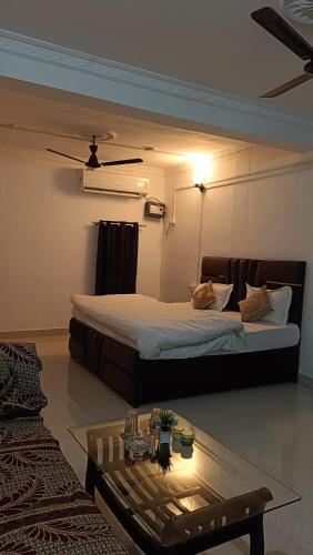 a hotel room with two beds and a coffee table at Shanti Sadan Homestay in Rājgarh