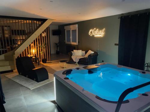 - une grande baignoire bleue dans le salon dans l'établissement Xclusif Love room, à Oppy