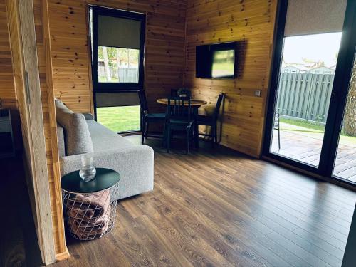 a living room with a couch and a table at NB Houses Šventoji in Šventoji
