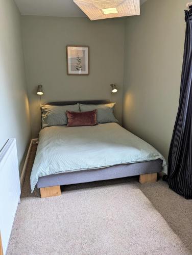 a bedroom with a bed in a room at The Cob House. in Ifton Heath