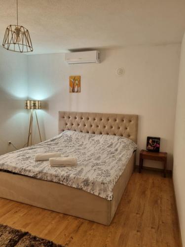 a bedroom with a large bed with a large mattressvisor at Onur Apartment 's in Prizren