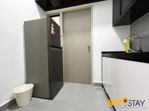 a kitchen with a sink and a door in it at Youth City Residence Family Suite KLIA AEON Mall Nilai USIM in Nilai