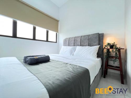 a bedroom with a large bed with a headboard at Youth City Residence Family Suite KLIA AEON Mall Nilai USIM in Nilai