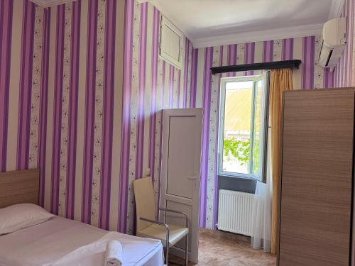 a bedroom with a bed and a window at Nina two in K'obulet'i
