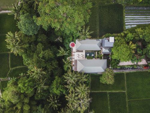 an overhead view of a house in the midst of trees at Suara Alam Hotel Ubud by Ini Vie Hospitality in Ubud