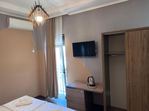 a room with a bed and a desk and a window at Nina two in K'obulet'i