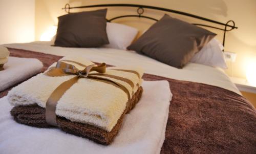 a bed with a blanket with a bow on it at Vatican Rhome in Rome