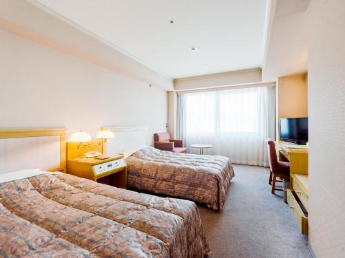 Postel nebo postele na pokoji v ubytování Hotel Pearl City Kobe