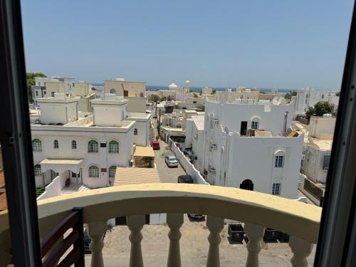 a view of a city from a balcony at Al Ferdous Hotel Apartments in Muscat