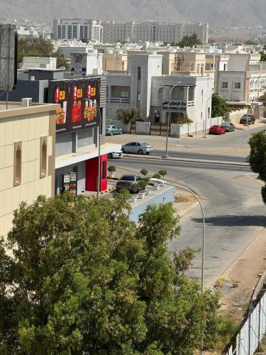 a view of a city with a parking lot at Al Ferdous Hotel Apartments in Muscat