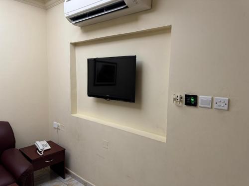 a flat screen tv hanging on a wall at Al Ferdous Hotel Apartments in Muscat