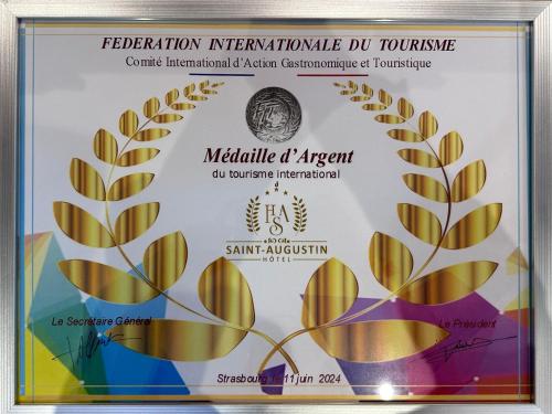 a framed diploma with a medal on it at Hotel Saint Augustin in Strasbourg
