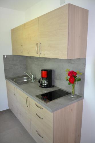 a kitchen with a sink and a vase of flowers at Schillerhof in Bad Füssing